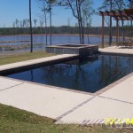 Newly constructed pool with raised spa with spill over finished in Florida Stucco's Lagoon