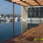 New construction swimming pool built with vanishing edge finished in Maui Midnight Hydrazzo 1of 2