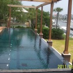 New construction swimming pool built with vanishing edge finished in Maui Midnight Hydrazzo 2 of 2