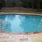Completed pool after renovation with spa removed and a sunledge added along with renovated deck